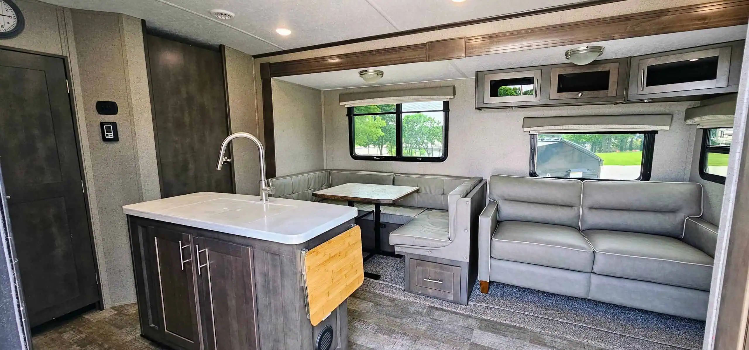 RV interior with kitchen and dining area.