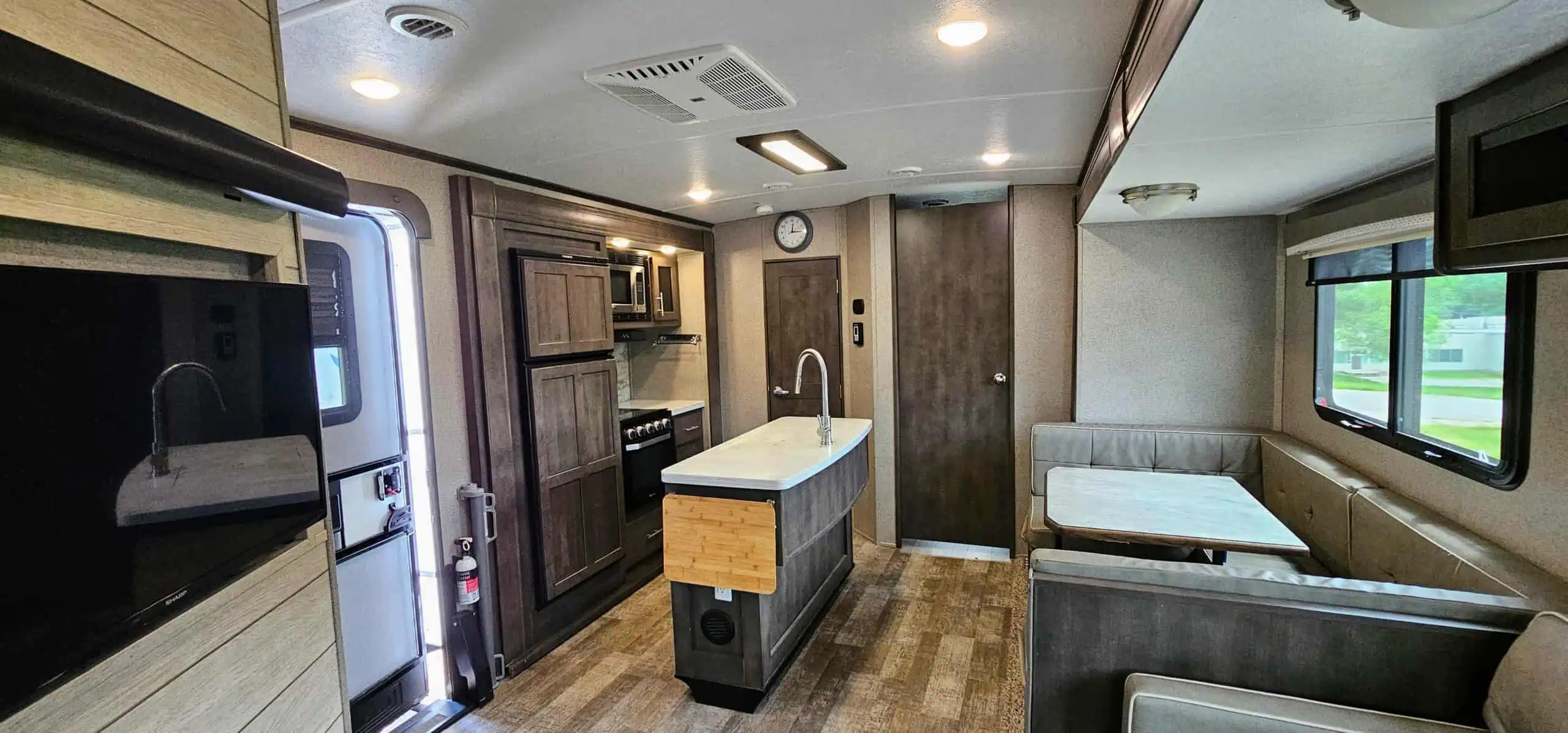 Modern RV kitchen and dining area.