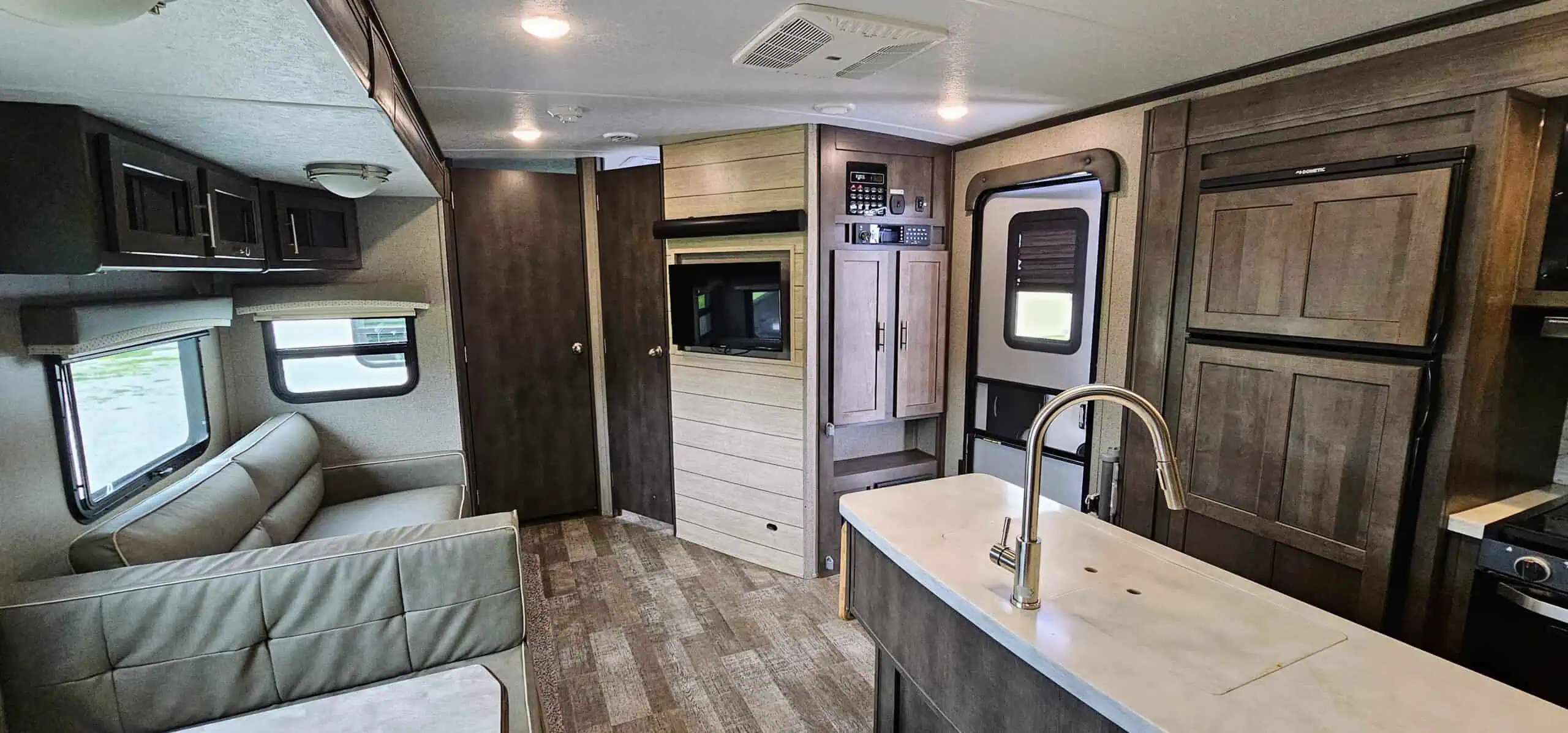 Interior of luxury RV with kitchen and seating.