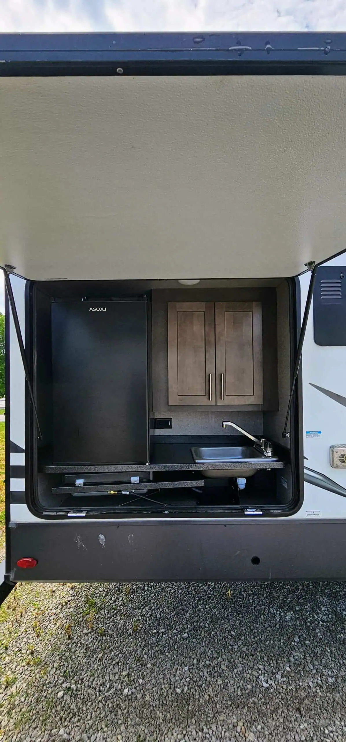 RV outdoor kitchenette with fridge and sink