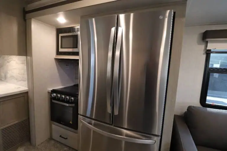 Modern kitchen with stainless steel refrigerator and oven.