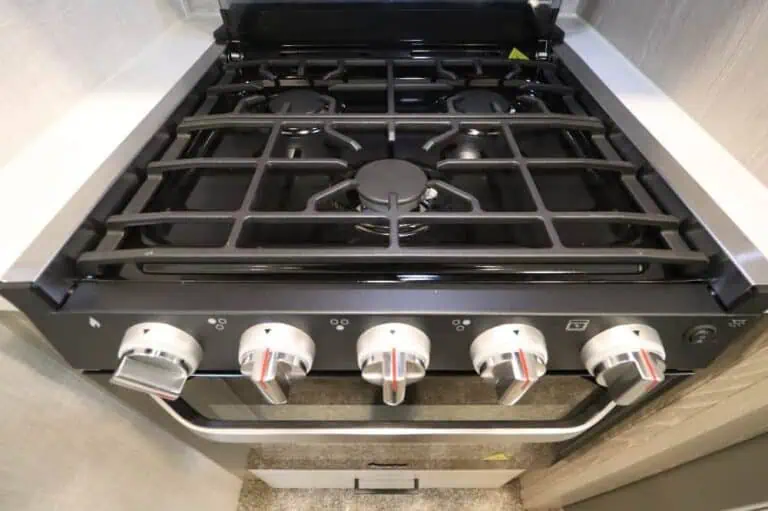 Modern gas stove with four burners and knobs