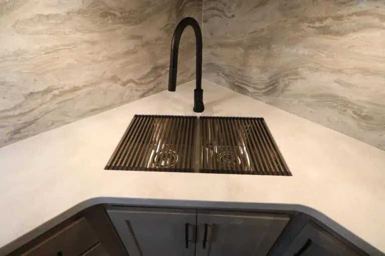 Modern kitchen sink with black faucet.