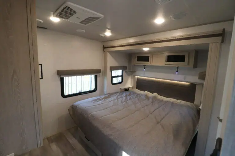 Cozy camper bedroom with queen bed.