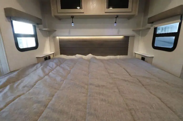 Spacious RV bedroom with bed and windows