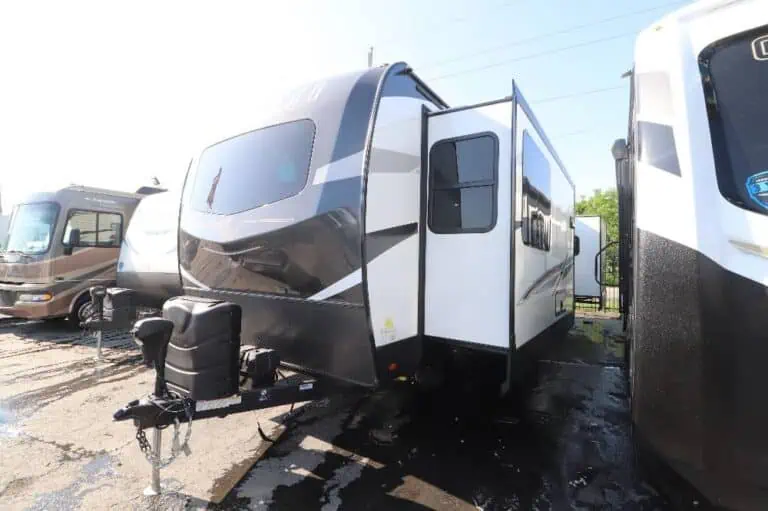 New travel trailers parked in a lot.