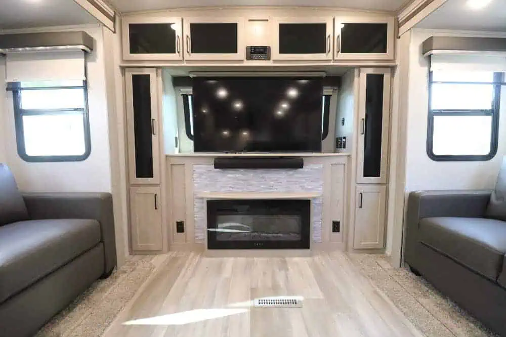 Spacious RV interior with TV and fireplace