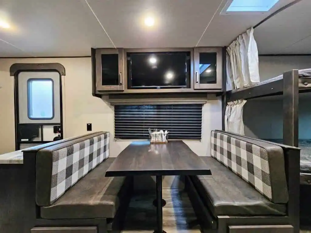 RV interior with dining table and bunk beds