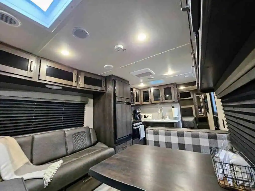 Modern RV interior with kitchenette and sofa.