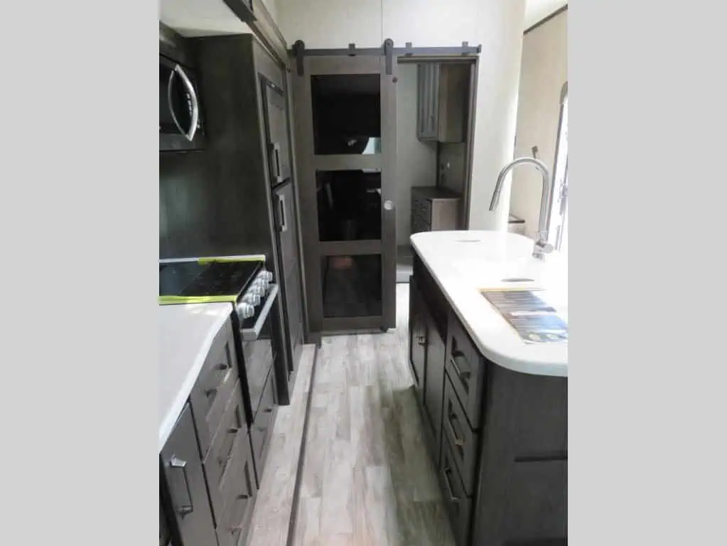 Modern kitchen interior with gray cabinets and counters.